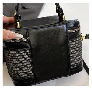 Detailed close-up of high-quality leather and textured fabric stitching on a semi-circle box bag
