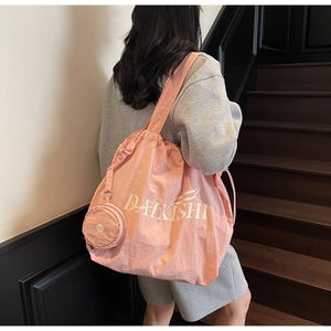 Pink drawstring tote bag with letter print and small round coin purse attachment