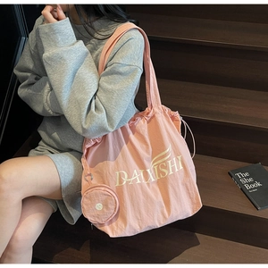 Pink canvas tote bag with matching coin purse shown on a wooden staircase background