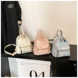 Detail of mini PU leather and lace jacquard backpacks with butterfly embroidery in 3 colors