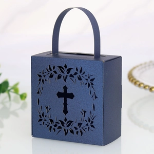 Close-up of laser-cut cross design on navy pearl paper wedding favor candy box