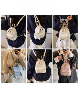 Detailed views of mini backpacks with butterfly embroidery in white, blue, and pink colors