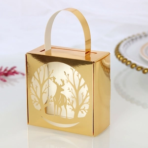 Close-up of golden Christmas reindeer laser-cut candy box with elegant hollow forest pattern