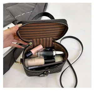 Detail view of woven texture vanity case with striped lining and large storage space