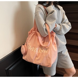 Pink large capacity nylon tote bag with drawstring detail and round zip pouch on shoulder
