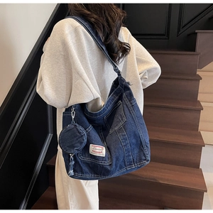 Detail of large denim tote bag in dark blue wash with detachable coin purse for commute