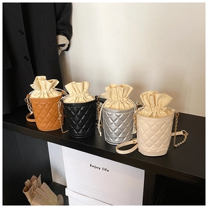Detailed display of four quilted bucket bags in brown, black, silver, and beige colors