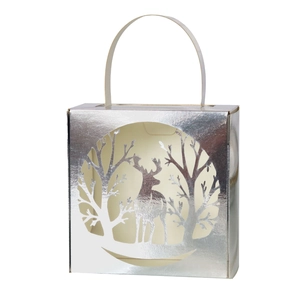 Detail of silver laser-cut candy box featuring reindeer and forest silhouette cutout