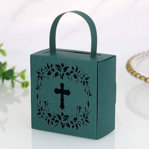 Detail of laser-cut cross and wreath pattern on dark green hollow paper gift box