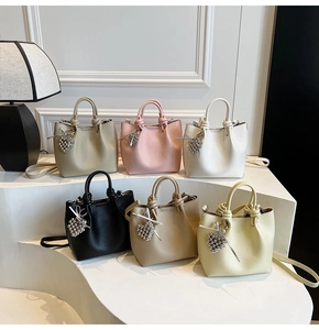Group display of leather bucket bags in six colors with heart pendant details
