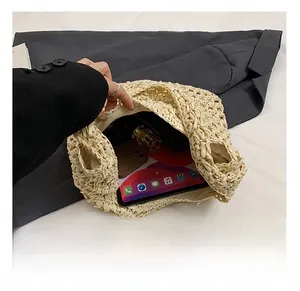Top view of large straw tote bag showing internal storage for tablets and daily essentials