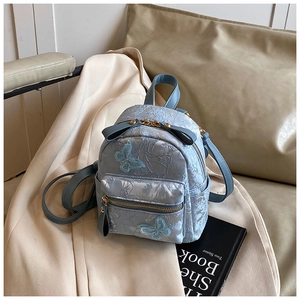 Detail of light blue floral jacquard mini backpack with embroidered butterfly appliques