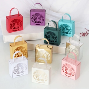 Detailed laser-cut elk patterns on multi-colored festive candy gift boxes with handles