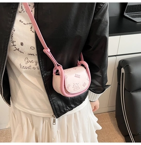 Detailed close-up of a pink mini crossbody bag featuring cute cartoon bear patterns
