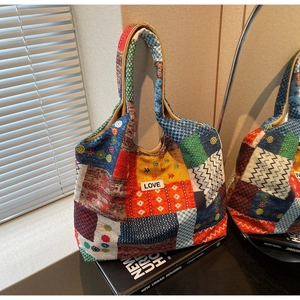 Detailed close-up of Bohemian patchwork tote bag with LOVE patch and colorful patterns