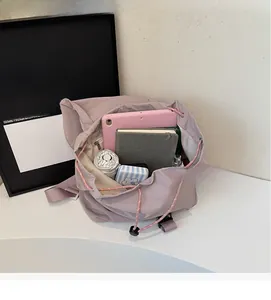 Spacious drawstring bucket backpack showing large capacity for tablet and umbrella