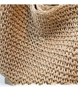 Detail shot of handwoven straw bag showing natural fiber texture and beige fabric lining