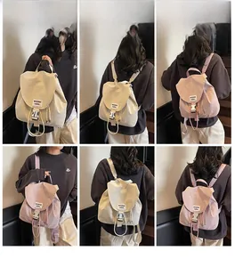 Detailed views of casual drawstring bucket backpack with buckle flap and woven labels
