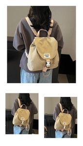 Detail of khaki drawstring bucket backpack with flap buckle and woven text label