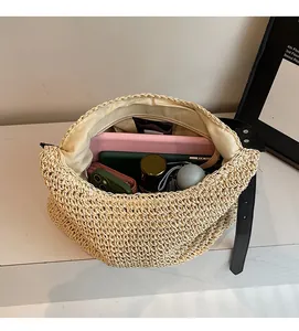 Top view of spacious straw tote interior showing phone, wallet, and sun umbrella storage