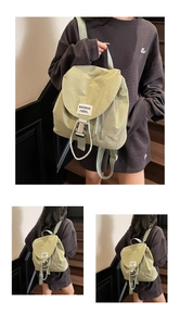 Detail of light green waterproof drawstring backpack with buckle and logo label
