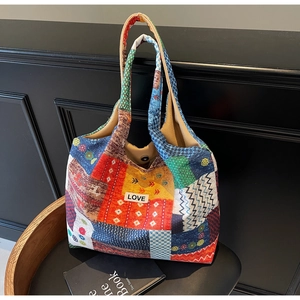 Macro detail of patchwork hobo tote showing mixed floral patterns and LOVE label