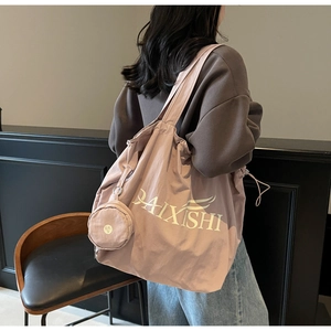 Detail of dusty pink canvas tote bag with drawstring closure and matching round pouch