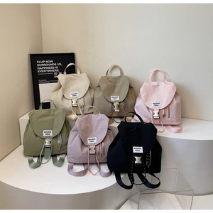 Detailed display of colorful nylon drawstring backpacks in six trendy pastel colors