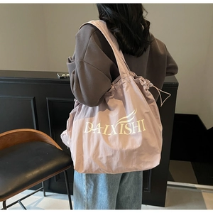 Detail of lavender canvas tote bag with drawstring closure and large interior capacity