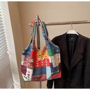 Close-up of a large canvas tote bag featuring vibrant geometric patterns and LOVE label