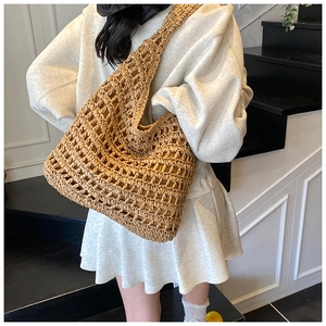 Detail of hollow woven shoulder tote bag with large capacity for beach vacation style