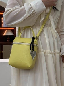 Bright yellow lychee pattern crossbody bag with heart pendant and silver zippers
