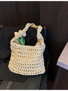 Large cream woven straw tote bag with hollow knit design for beach vacation and travel