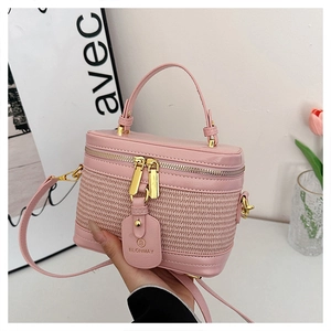 Detailed macro of pink woven box bag featuring gold zipper and BLONMAY leather tag