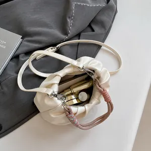 Internal capacity of off-white pleated cloud bag with phone and makeup essentials