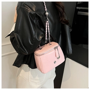 Detail of light pink mini box bag with silver flower logo and ball adjustable chain