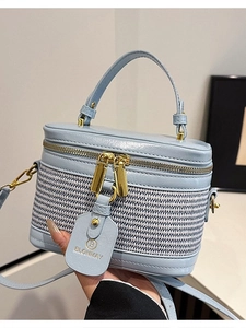 Light blue mini box bag featuring woven texture and golden dual zippers with top handle