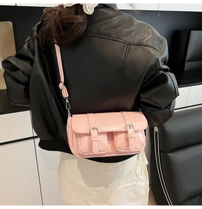 Detail view of pink vintage pillow bag with silver buckles and adjustable strap