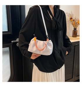 Detail of ruched cloud bag with colorful braided rope handle and slim leather strap