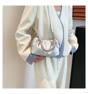 Silver metallic pleated cloud bag featuring pink woven rope handle shown on model