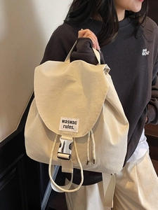 Minimalist cream drawstring backpack with metal buckle and adjustable shoulder straps