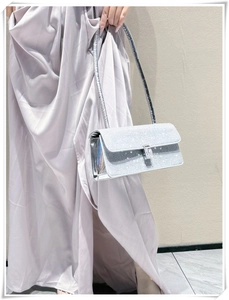 Detail of silver sparkling rhinestone evening bag with elegant crystal buckle