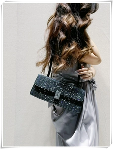 Macro detail of sparkly rhinestone baguette bag with elegant silver rectangle lock