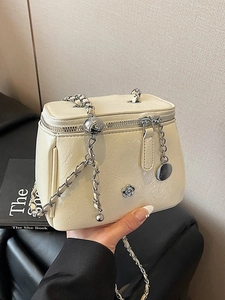 Chic cream vanity case handbag with camellia emblem and leather-woven chain strap