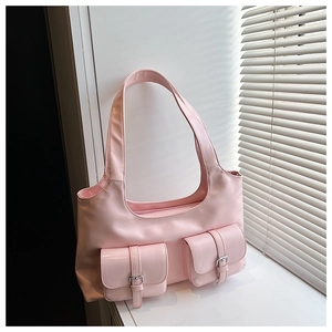 Close-up of light pink Y2K style shoulder bag with double pockets and silver buckles