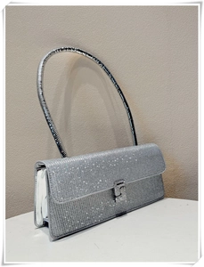 Close-up of silver rhinestone evening bag with luxury metallic handle and clasp
