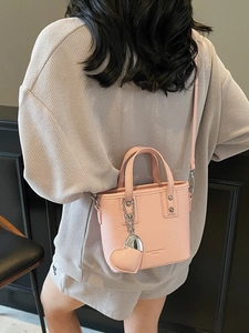 Pink lychee grain bucket bag with heart pendant and adjustable strap for women