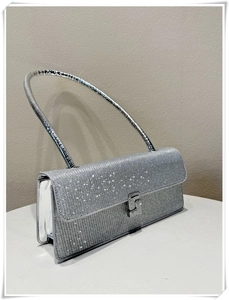 Macro detail of high-density rhinestone evening bag with silver metallic handle and clasp