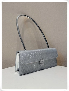 Detail of silver rhinestone baguette bag showing shiny glitter texture and handle