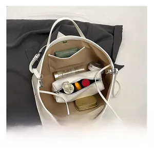 Interior view of large white tote bag showing spacious capacity and organized storage